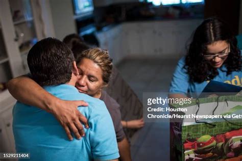 Celia Rodriguez embraces her husband Juan Rodriguez while .